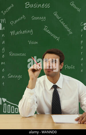 Businessman with business wording on the board in the background Stock Photo
