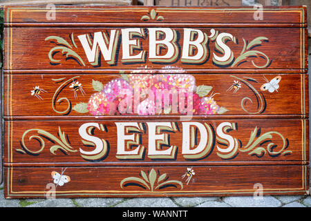 Vintage hand painted wooden seed sign outside a shop in Stow on the wold, Cotswolds, Gloucestershire, England Stock Photo