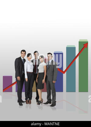 Business executives standing in front of bar graph rising upward Stock Photo