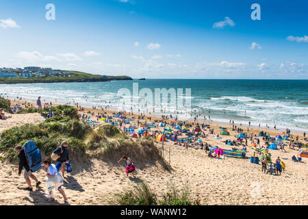 Holidaymakers on a staycation holiday on a sunny Fistral Beach in Newquay in Cornwall. Stock Photo