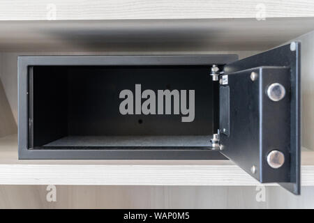 black safe box, stroungbox in the wood pattern shelf in resort bedroom. Stock Photo