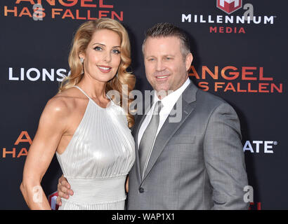 WESTWOOD, CA - AUGUST 20: Director Ric Roman Waugh (R) and wife Tanya Lynn Waugh attend the LA Premiere of Lionsgate's 'Angel Has Fallen' at Regency Village Theatre on August 20, 2019 in Westwood, California. Stock Photo