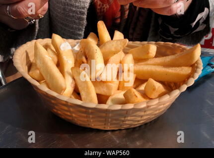 AJAXNETPHOTO. 2014. WORTHING, ENGLAND. - DEEP FRIED POTATO CHIPS IN A PLASTIC BASKET.PHOTO:JONATHAN EASTLAND/AJAX REF:GXR141607 405 Stock Photo