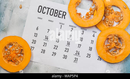 Fall concept. October 2019 Paper Calendar with round slices of pumpkin Stock Photo