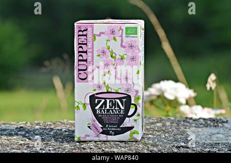 Packaging of Cupper "Zen Balance" Infusion of lemongrass, eucalyptus and ginkgo, photographed on a concrete fence wall, in a village in Montenegro Stock Photo