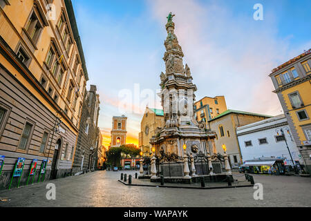 Naples, Italy - 19 April 2019: Gesu Nuovo square in historical old town center of Naples with Guglia dell'Immacolata obelisk Santa Chiara church is an Stock Photo