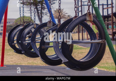 Waterfront, Cape Town, South Africa - December 2, 2017: Swings with empty tires at a waterfront park in Cape Town Stock Photo