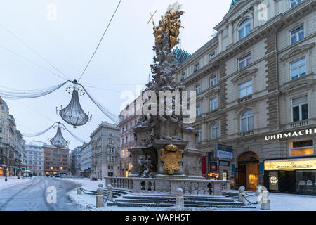 Plague Column (Holy Trinity column) and christmas ornaments in the iconic Graben street, famous for shopping, Vienna, Austria Stock Photo