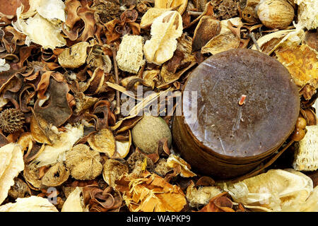 Close up shot of aromatic candle with potpourri Stock Photo