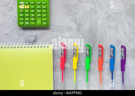Multicolored gel pens on a gray background. Education, back to school or freelancer concept, flat lay, top view, social media hero header template, co Stock Photo