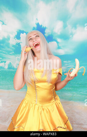 lady with pink lips holding banana like phone talk speak chat conversation Stock Photo