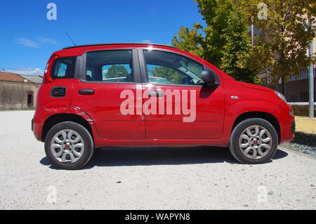 Peschiera del Garda, Italy - August 12, 2017: Red damaged Fiat Panda parked on a public parking lot in the city of Peschiera del Garda. Stock Photo