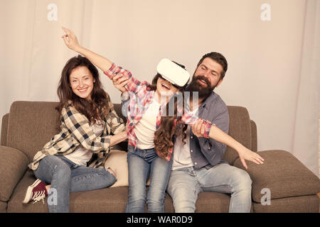 Daughter stuck in virtual reality. Lot of concern surrounding children using VR headsets. Digital world. Virtual life and dependence. Parents worry about kid in virtual reality. Virtual cyber gaming. Stock Photo