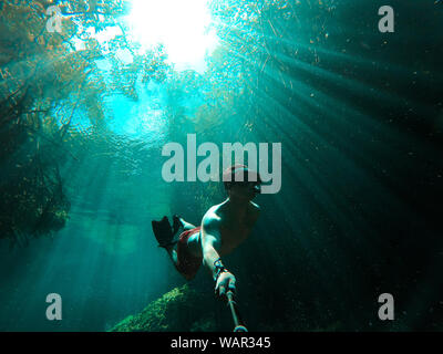 Man takes selfie while freediving in Casa Cenote in Tulum, Quintana Roo, Mexico. Stock Photo