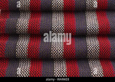 Red, gray and white striped scarf. Close up detail. Stock Photo