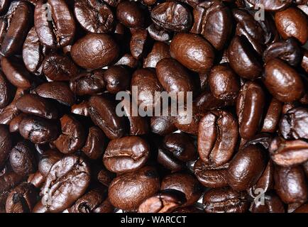 Close-up Dark brown roasted coffee beans, Raw processed food for drinks refreshment. Stock Photo