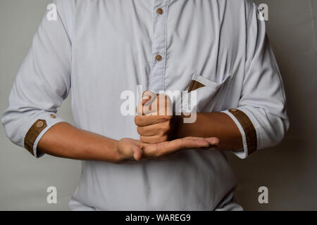 Close up Asian man shows hand gestures it means HELP isolated on white background. American sign language Stock Photo