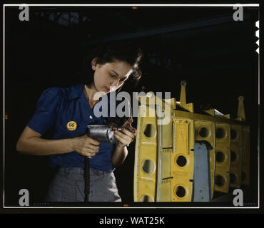 Drilling horizontal stabilizers: operating a hand drill, this woman worker at Vultee-Nashville is shown working on the horizontal stabilizer for a Vultee Vengeance dive bomber, Tennessee. The Vengeance (A-31) was originally designed for the French. It was later adopted by the R.A.F. and still later by the U.S. Army Air Forces. It is a single-engine, low-wing plane, carrying a crew of two men and having six machine guns of varying calibers Stock Photo