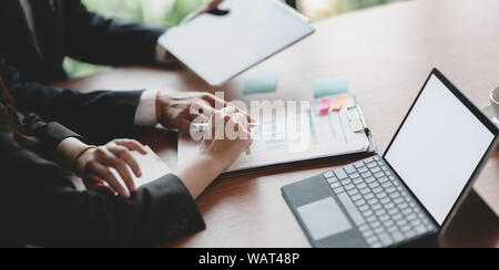 Close-up view of business team planing the project with charts and graphs while using tablet on the table Stock Photo