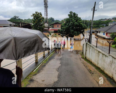 NILAMBUR, KERALA, INDIA - AUGUST 09, 2019: People gathered near the flood-affected street in Janathapadi, Nilambur. Stock Photo