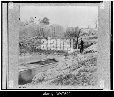 Dutch Gap Canal [...] November 1864, while Canal was being dug Abstract: Soldier standing on cliff of canal. Stock Photo