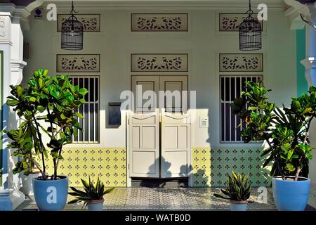 Colourful entrance to traditional Peranakan shop house with bifold doors, Chinese wall tiles historic Spottiswood Park, Singapore Stock Photo