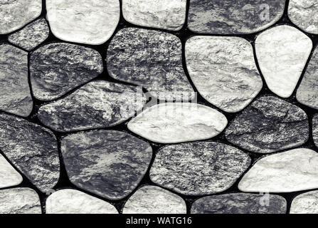Wall of small stone texture background. endless seamless background fill. Stock Photo