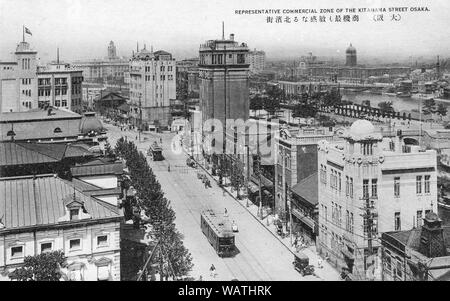 [ 1920s Japan - Business District in Osaka ] —   Osaka’s business district of Kitahama and the local government seat on Nakanoshima, an island sandwiched between the Dojima and Tosabori Rivers.   Osaka has already been thoroughly modernized. Two buildings with towers can be seen. The one on the right is the District Court. The other one Osaka City Hall.  The tall structure in the middle of the image is the Kitahama Building.  20th century vintage postcard. Stock Photo