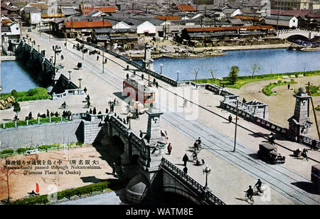 [ 1920s Japan - Naniwabashi Bridge, Osaka ] —   Naniwa Bridge in Osaka. The bridge spans the Old Yodo River and was completed in 1915.   Naniwa Bridge was especially known for its lampposts and stone statues of lions. It featured impressive stone steps leading to Nakanoshima Island and the waterfront park which was under construction at the time the bridge was built. It still stands and is one of the oldest Western style bridges in Japan.  20th century vintage postcard. Stock Photo