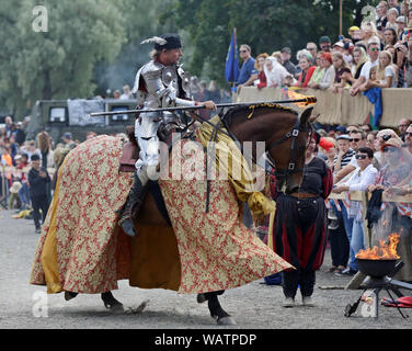 Hameenlinna Finland 08/17/2019 Medieval festival with craftsman, knights and entertainers. A parade with fire. A knight riding with his handsome horse Stock Photo