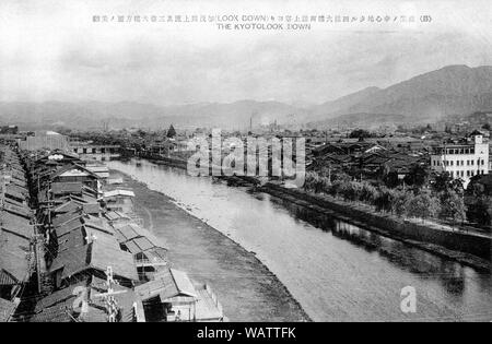 [ 1920s Japan - Kamogawa River, Kyoto ] —   Kamogawa River towards Sanjo Ohashi bridge as seen from Shijo Ohashi Bridge in central Kyoto.  20th century vintage postcard. Stock Photo