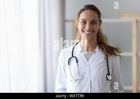 Smiling young female doctor wear medical uniform with stethoscope, portrait Stock Photo