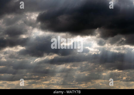 Dramatic sky panorama with sun rays between clouds. Idyllic sun beams cloudscape backdrop. Majestic cloud scenery Stock Photo