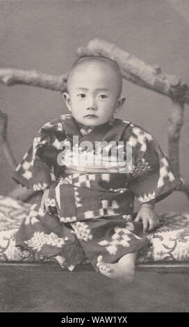 [ 1910s Japan - Japanese Baby Boy ] —   Photo of 1 year old baby girl in ceremonial kimono. During the early 20th century it was a very popular custom in Japan to take photographs of babies around their first birthday.  20th century vintage gelatin silver print. Stock Photo