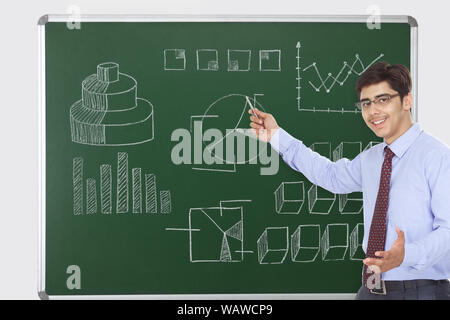 Businessman giving presentation on blackboard Stock Photo