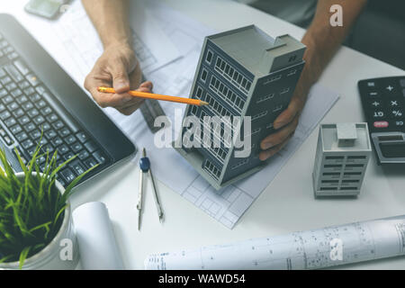 real estate development - construction engineer working on new house project in office Stock Photo