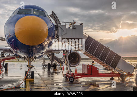 Jet airliner with passenger stairs Stock Photo