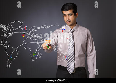 Businessman touching currency symbols on a touch screen representing countries in a world map Stock Photo