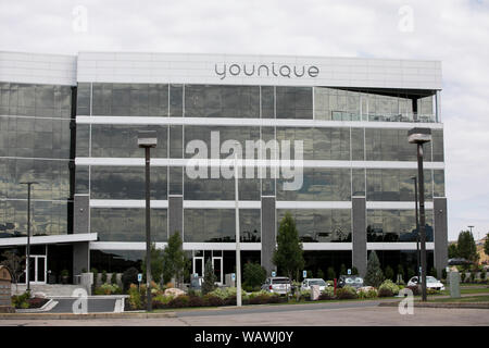 A logo sign outside of the headquarters of Younique in Lehi, Utah on July 27, 2019. Stock Photo