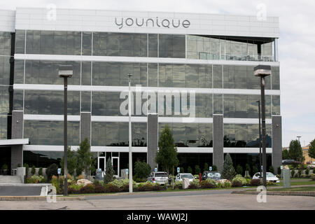 A logo sign outside of the headquarters of Younique in Lehi, Utah on July 27, 2019. Stock Photo