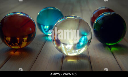 Still life photography of five colorful glass balls in the sunny beams. High resolution macro photography. Stock Photo