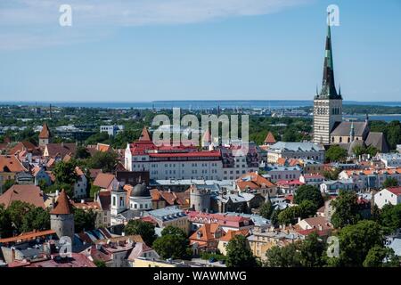 City view with St Olaf's Church or Oleviste Kirik and harbour at the Baltic Sea, seen from the tower of Toomkirik Cathedral, Tallinn, Estonia Stock Photo