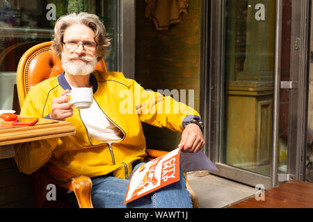 Man drinking his morning coffee thiking over stroll. Stock Photo