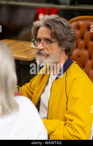 Thoughtful man drinking smoothie with his wife. Stock Photo