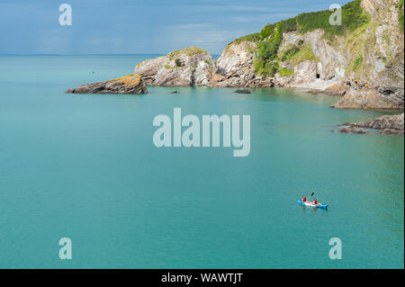 Kayak in the sea, in the Combe Martin bay. Combe Martin is a village, civil parish and former manor on the North Devon coast Stock Photo