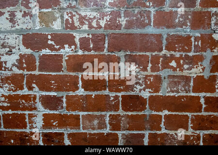 Vintage brick wall with peeling white paint background texture Stock Photo