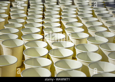 Long rows of white cups with water in perspective pattern Stock Photo