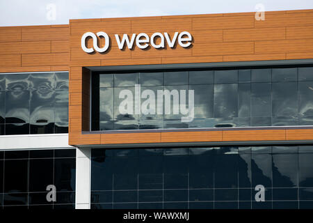 A logo sign outside of a facility occupied by software provider Weave in Lehi, Utah on July 27, 2019. Stock Photo