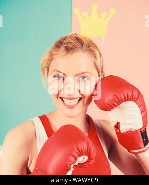 Fight for success. VIP gym. Fighting queen. Woman boxing glove and crown symbol of princess. Queen of sport. Become best in boxing sport. Feminine tender blonde with queen crown wear boxing gloves. Stock Photo