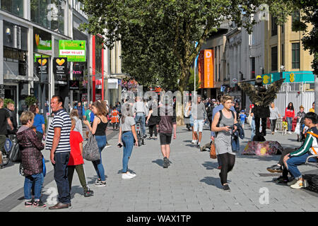 Cardiff Queen Street shopping area people shoppers walking past shops on a sunny day in summer July 2019 in Cardiff City Centre Wales UK  KATHY DEWITT Stock Photo